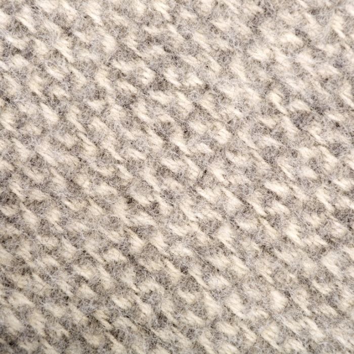 Detailed close up view of the grey and cream pattern of the illusion throw 