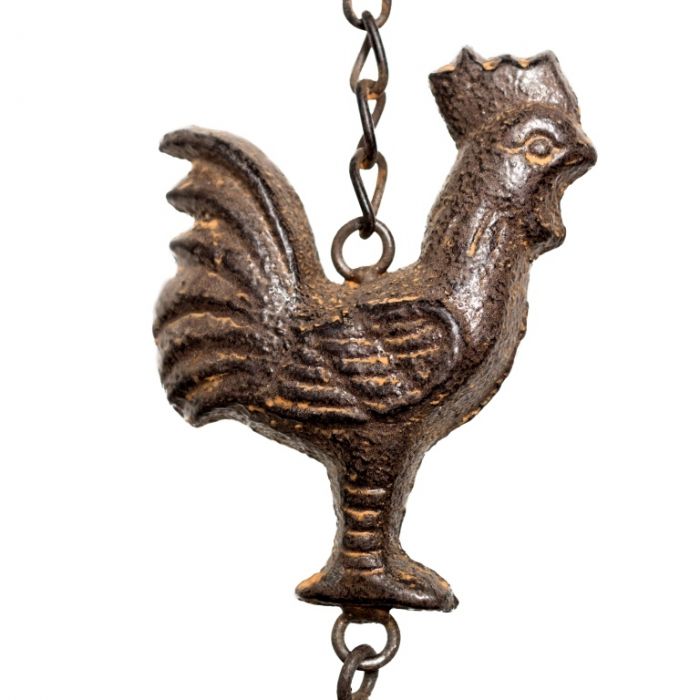 Detailed view of the metal cockerel that makes up this windchime, with his feathered wings and comb on his head