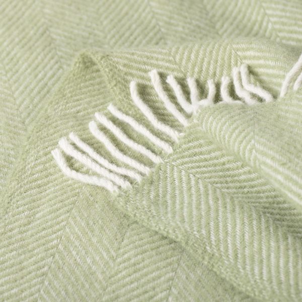 Close up of the Fern Green Fishbone Throw showing the texture and detailing.