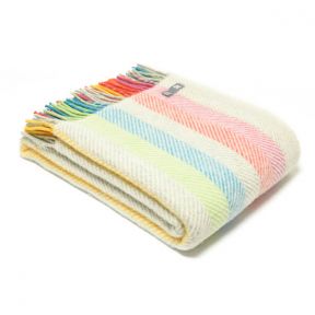 Three quarter view of Multicolour Fishbone Throw folded with tassels to the left.