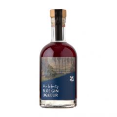 A deep red sloe gin liqueur in a clear glass bottle with a cork stopper and a pretty National Trust label