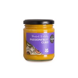 A jar of bright yellow passionfruit curd with a black lid and a Great Taste award on the purple label