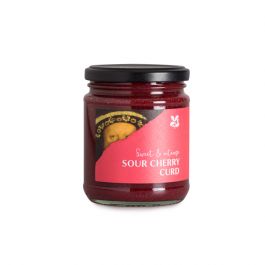 A deep red sour cherry curd in a glass jar with a black lid and a pink National Trust label and the Great Taste awards badge