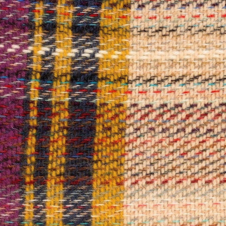 Close up of the Recycled Rug showing the multiple colours in the fabric and the texture detailing. 