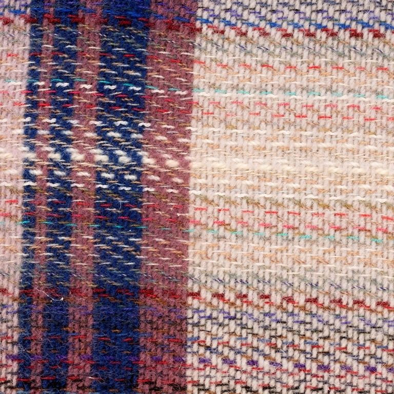 Close up of the Recycled Rug showing the multiple colours in the fabric and the texture detailing. 