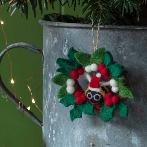 National Trust Felt Bee and Holly Wreath, image shows hanging decoration from Christmas tree. Part of the Christmas decorations range, browse the National Trust's collection for decorations that help look after National Trust places.