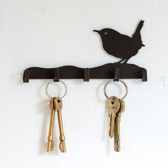 Wren Silhouette Key Hook. Image shows metal key hook with space for five sets of keys or five hook spaces on a plain textured wall.