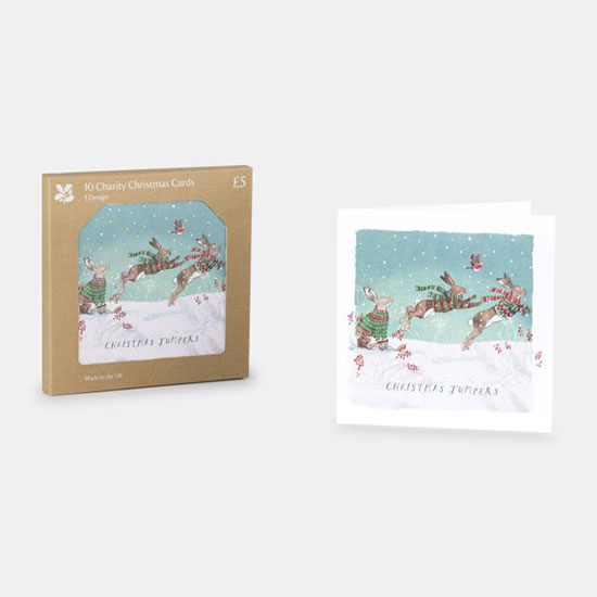 Christmas Cards - Christmas Jumpers. Box of 10 cards from the National Trust Christmas cards range - image shows square cards in kraft packaging on a plain grey background, card design includes hares in Christmas jumpers jumping in a snowy scene.