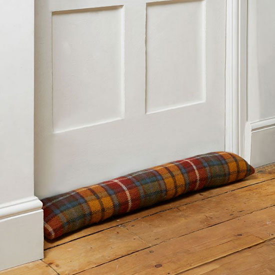 Wool Draught Excluder - Antique Buchanan. Image shows tartan draught excluder against white painted door, with red, orange and green coloured check print to compliment contemporary home decor.