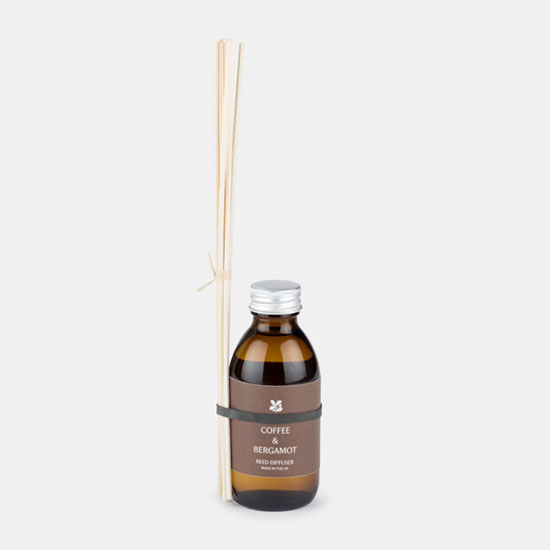 Reed Diffuser - Coffee and Bergamot (£18.00). Image shows reed diffuser with amber glass bottle and set of reeds on a plain grey background. The bottle features a brown label with the National Trust logo.