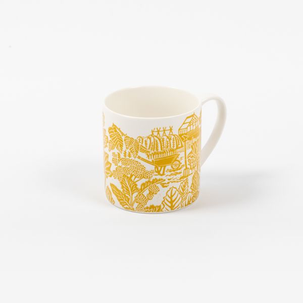 Kate Heiss Mustard Mug - £10.00, from the National Trust's new homeware and decorative accessories range. Image shows white ceramic mug on grey background, focusing on the bright bold yellow lino print design that features a lively gardening scene. Browse the range for unique and unusual gifts, from mugs and ceramics to vases, candles and decorative trinket dishes. Every purchase helps care fund vital conservation work.