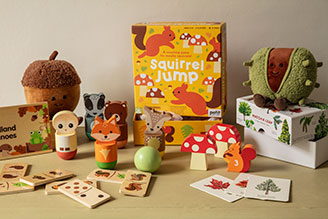 Children's games - image shows selection of toys and games from the National Trust children's range, including Squirrel Jump the board game, Jellycat soft toys Conker and Acorn, as well as the Match a Tree card game and Woodland Dominoes.