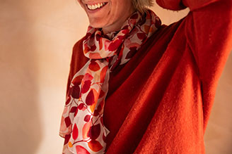 Scarves - image shows model wearing the Hinton Ampner inspired scarf from the new National Trust autumn winter range.