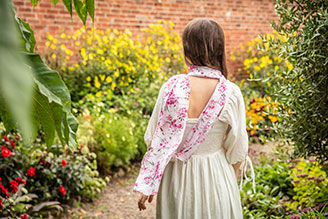 Scarves - image shows model wearing the Hinton Ampner inspired scarf from the new National Trust autumn winter range.